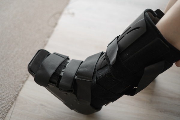 Close-up of female leg with black splint following a work injury.