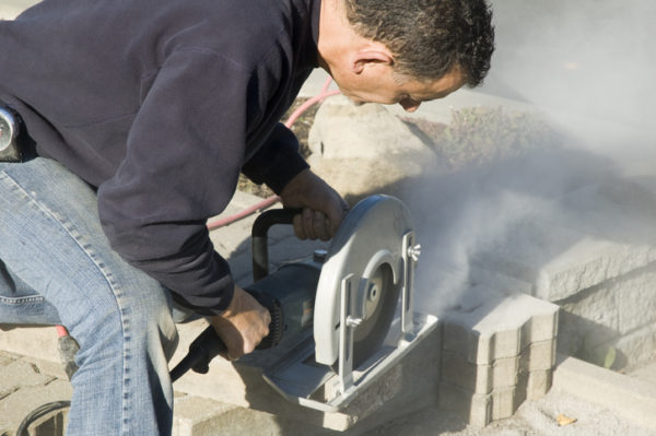 Pennsylvania masonry worker cuts stone in the summer
